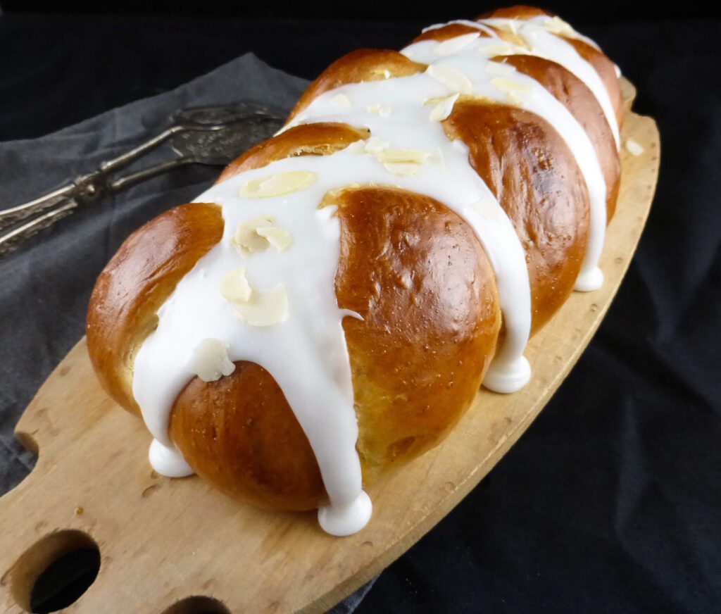 picture of a large loaf and two small plaits of cardamom bread