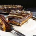 a close up of a chocolate caramel pie
