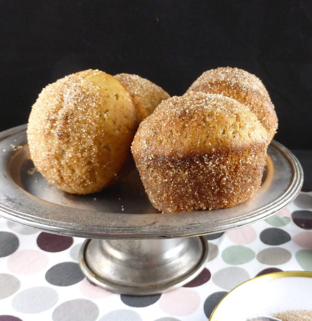 a picture of four muffins on a cake stand