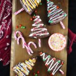 Five brownie Christmas trees on a wooden board