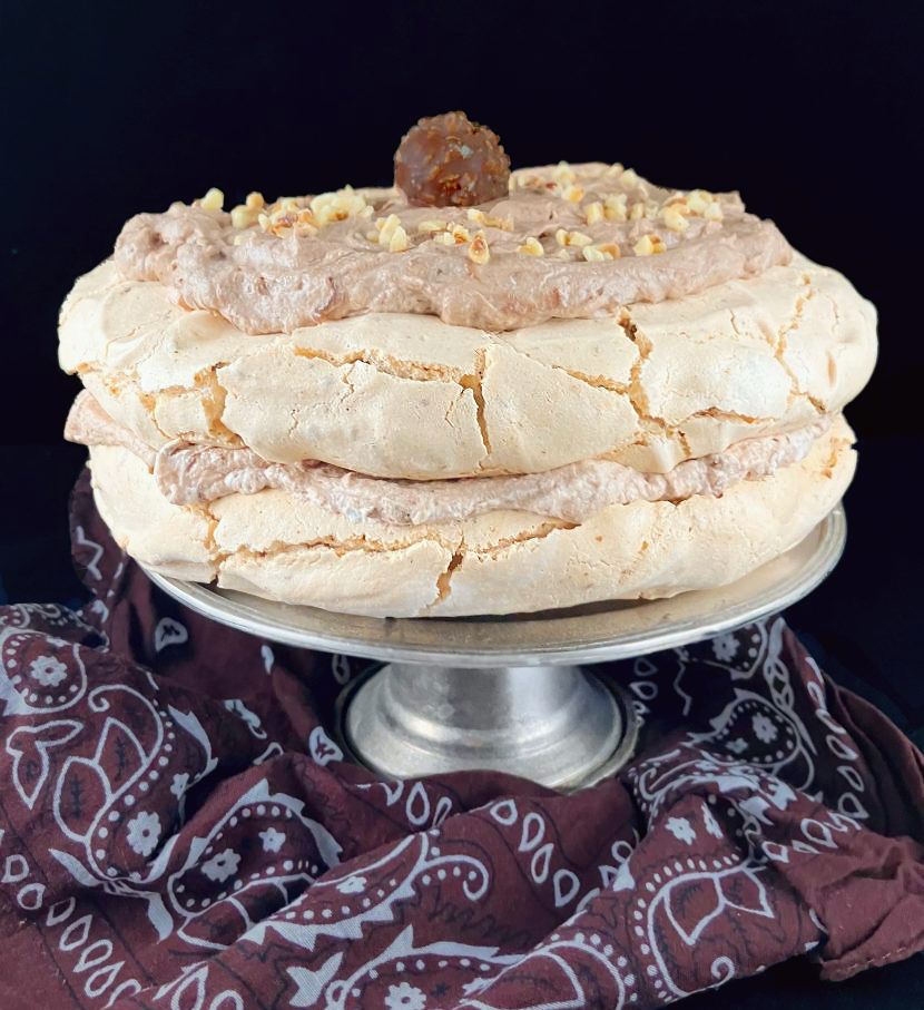 Front view of a double meringue dessert filled with Nutella and hazelnut cream