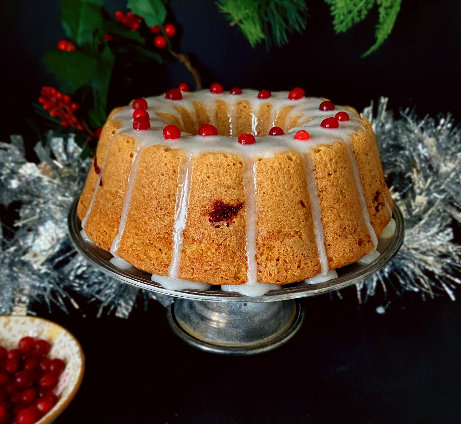 Side view of a festive Swedish soft gingerbread cake (mjuk pepparkaka) topped with lingonberries