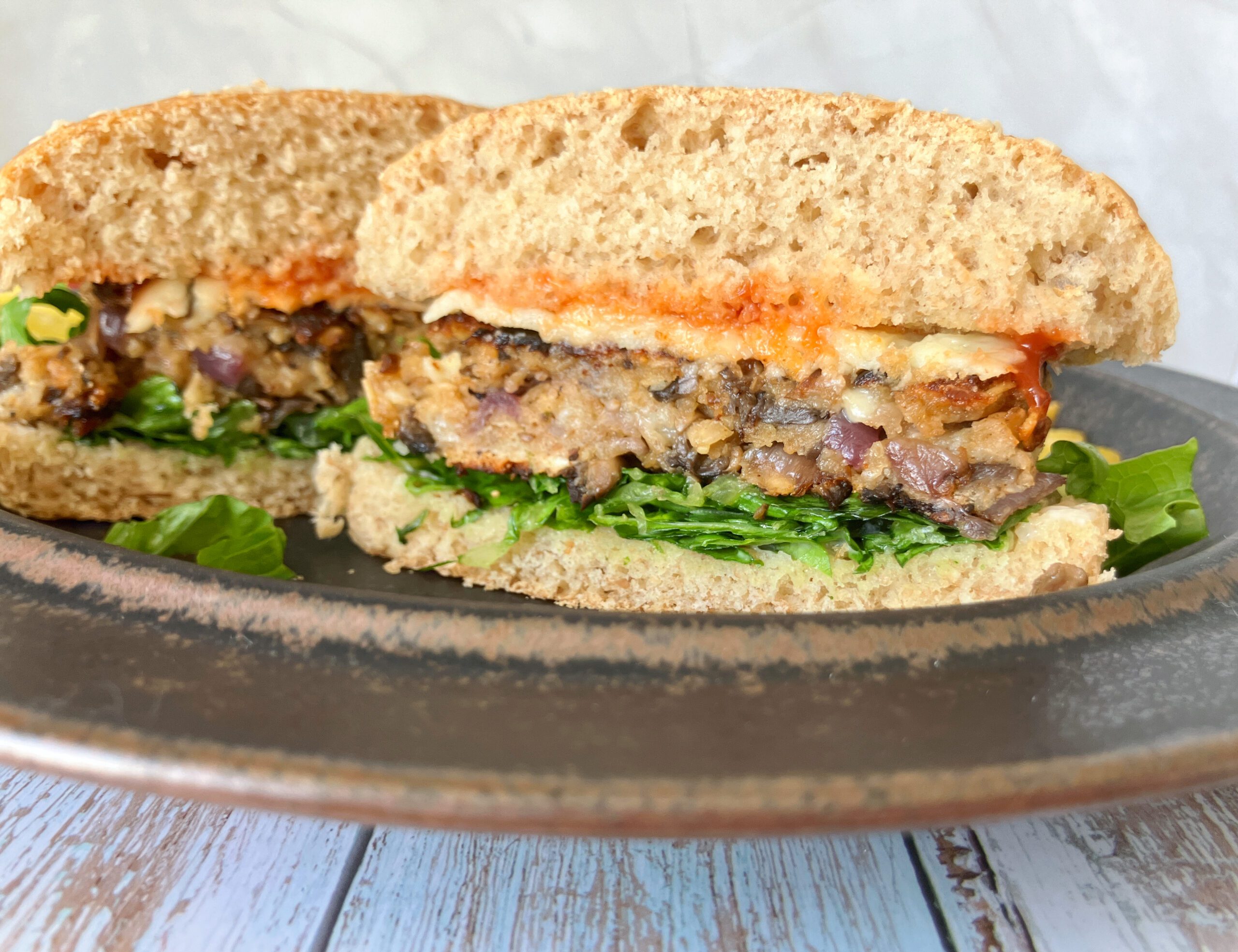 Close-up of a sliced mushroom burger, showing the moist, meaty texture inside