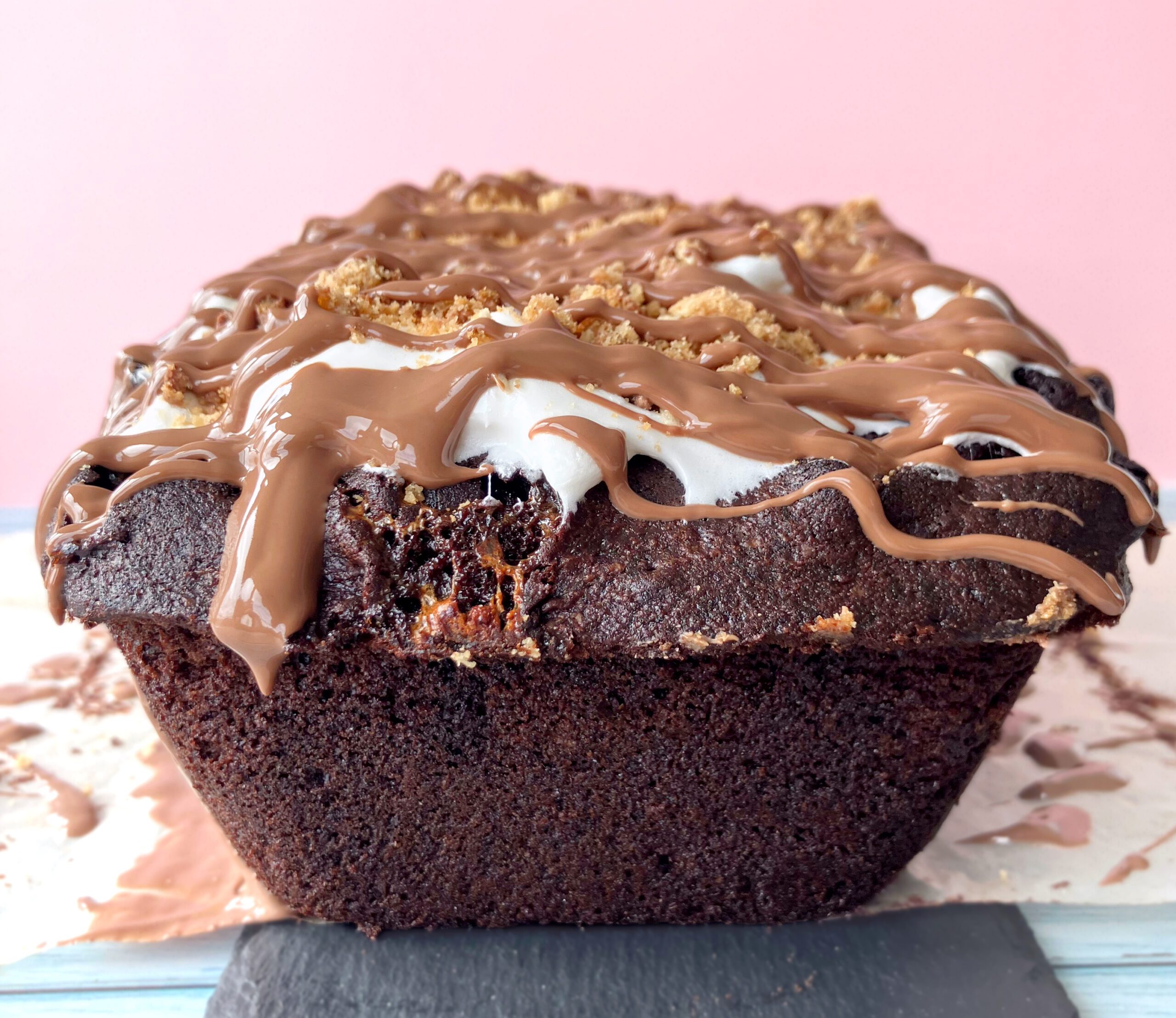 Chocolate cake with melted marshmallow swirls and softened cookie crumbs blending into the crumb