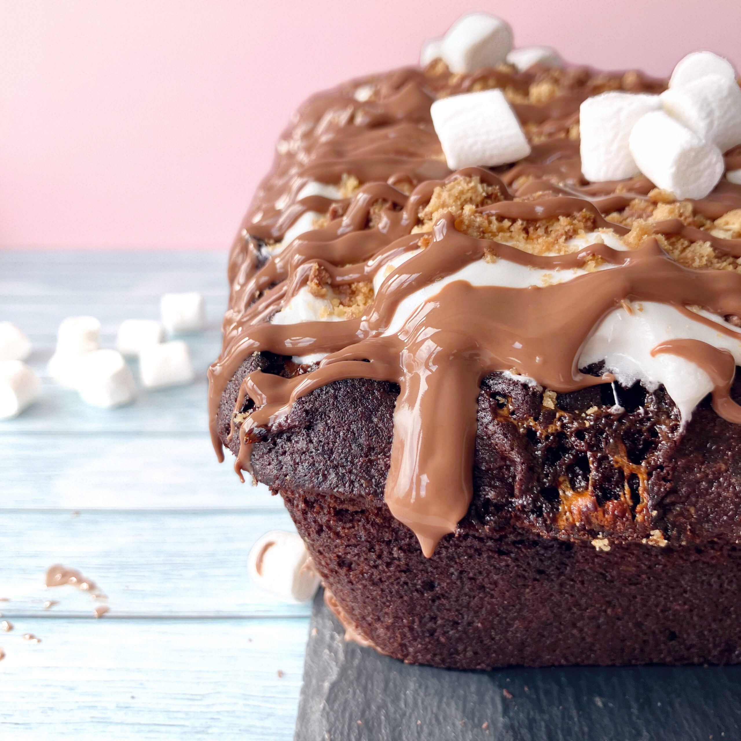 Chocolate cake with melted marshmallow swirls and softened cookie crumbs blending into the crumb
