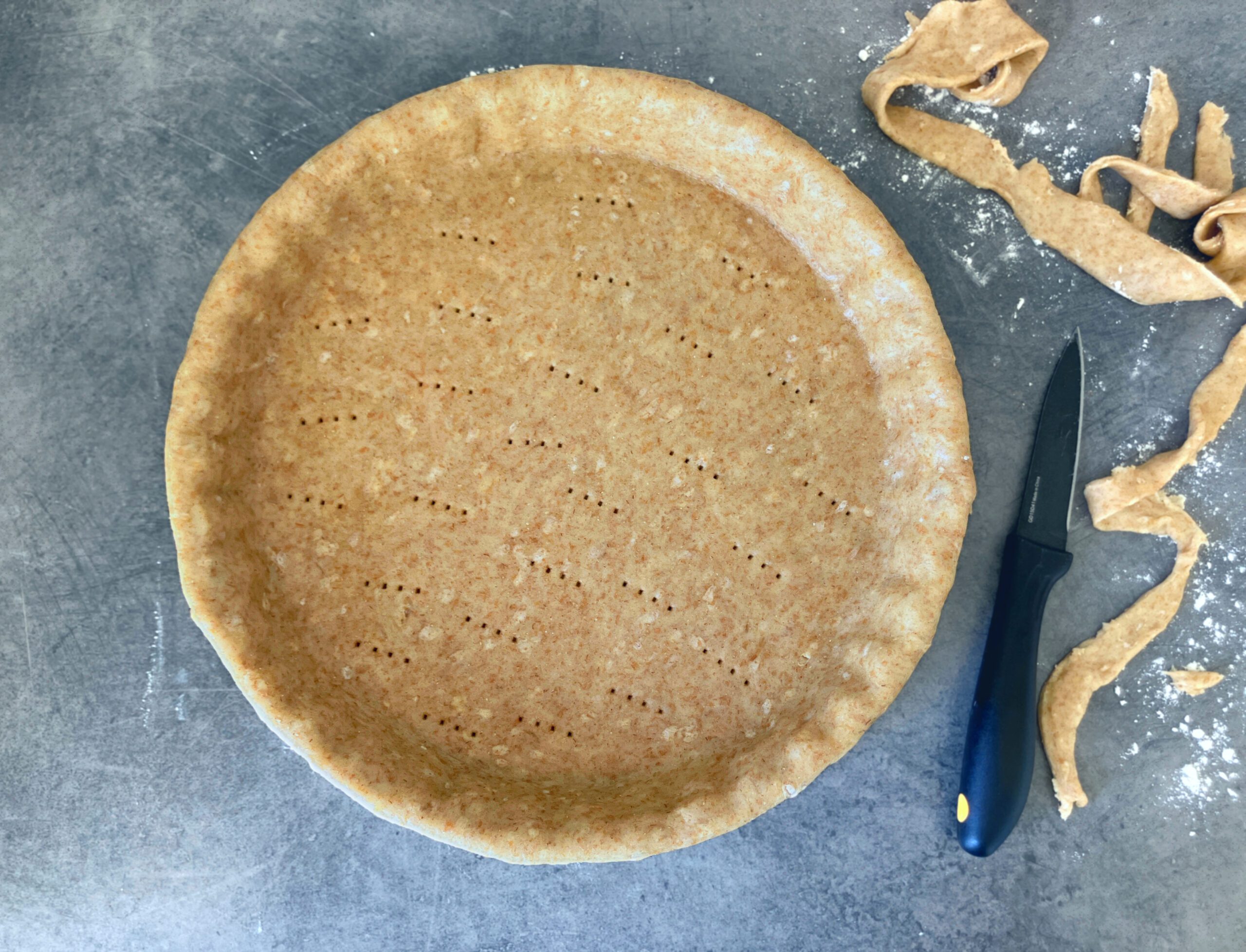 Overhead shot of an empty pastry crust made with olive oil and wholegrain spelt flour