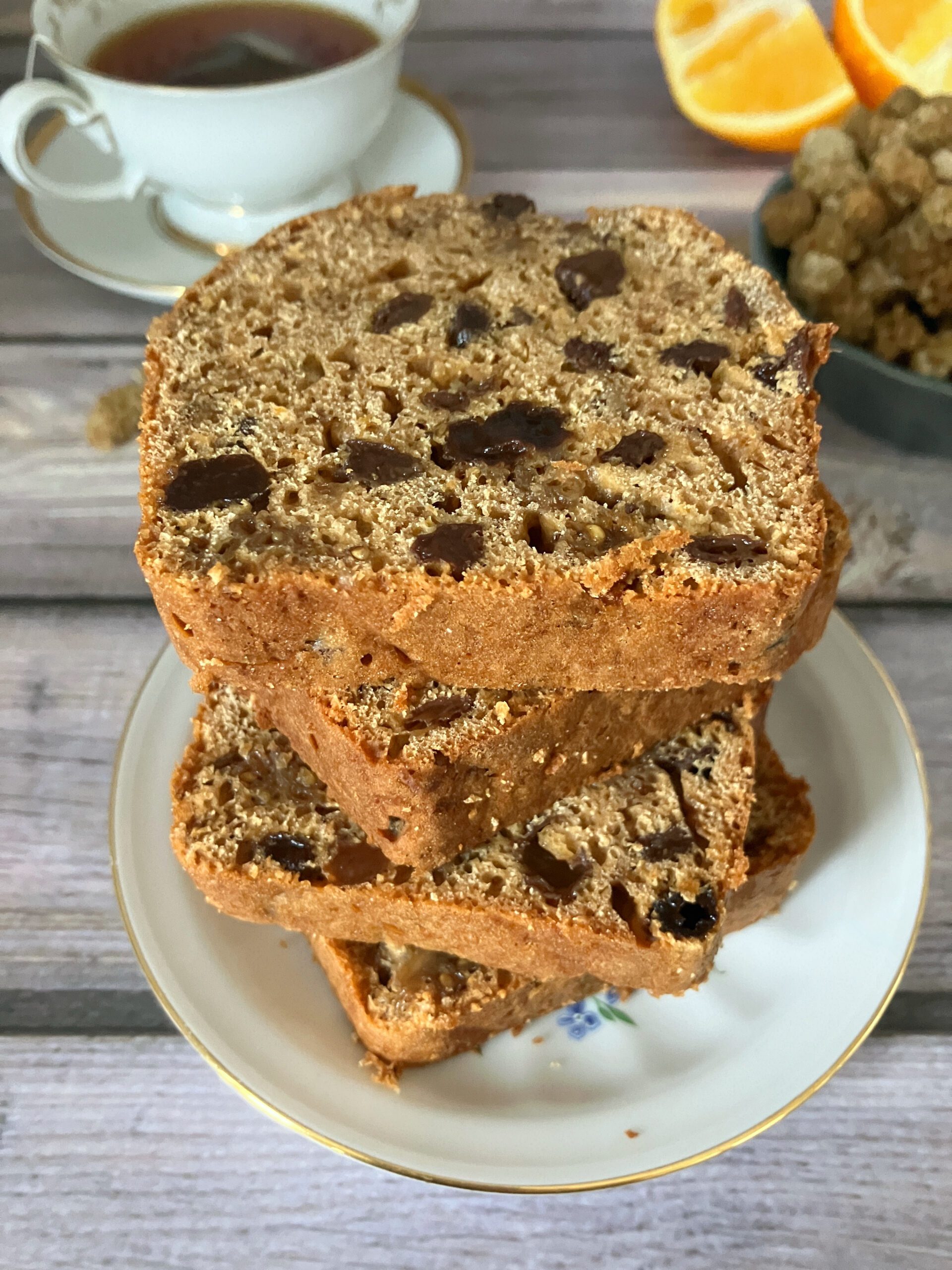Slices of dried mulberry tea loaf stacked on top of each other on a white plate